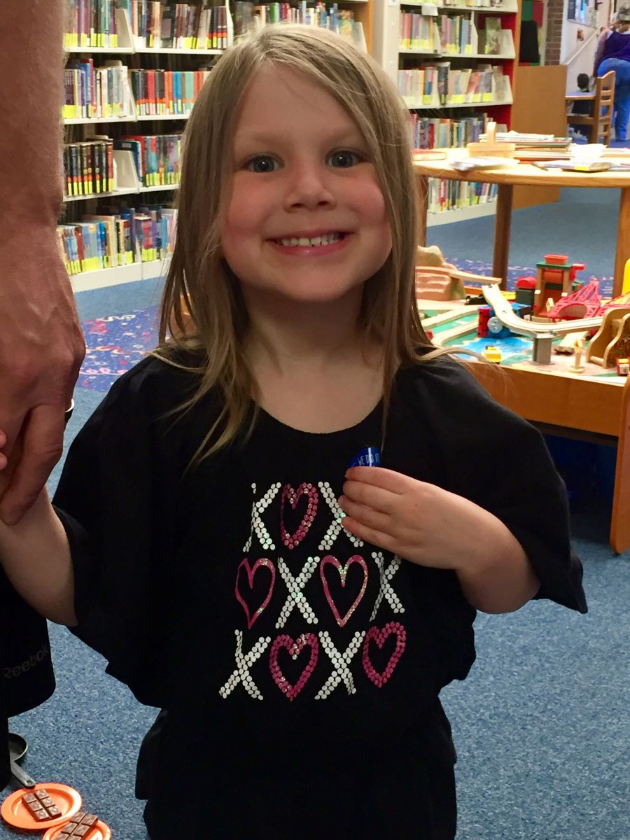 A photo of one of the children graduating from the 1,000 Books Before Kindergarten program